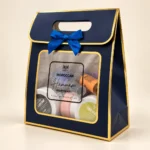 Moroccan Hammam Starter Kit with five jars, two bottles, a purple exfoliating mitt and a navy gift bag